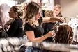 Hair stylist curling customers hair
