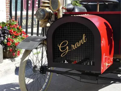 Old car beside parked beside flowers