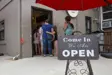 Customers lined up to enter a store