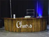 Wooden bar with 'cheers' sign on it