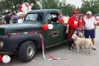 Family posing for picture in front of a truck