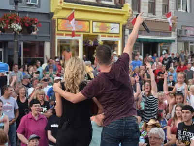Two performers in front of outdoor crowd 