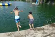 Children jumping into water