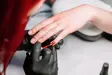Esthetician painting nails red